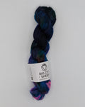 A single hank of variegated yarn with blue, purple, and pink tones, wrapped in a white paper label that reads 'Big City Sheep', displayed on a white background.